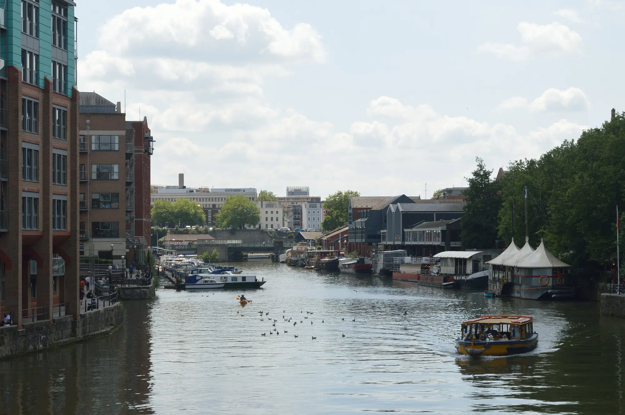 Bristol's Floating Harbour on a bright day, quays and moored boats