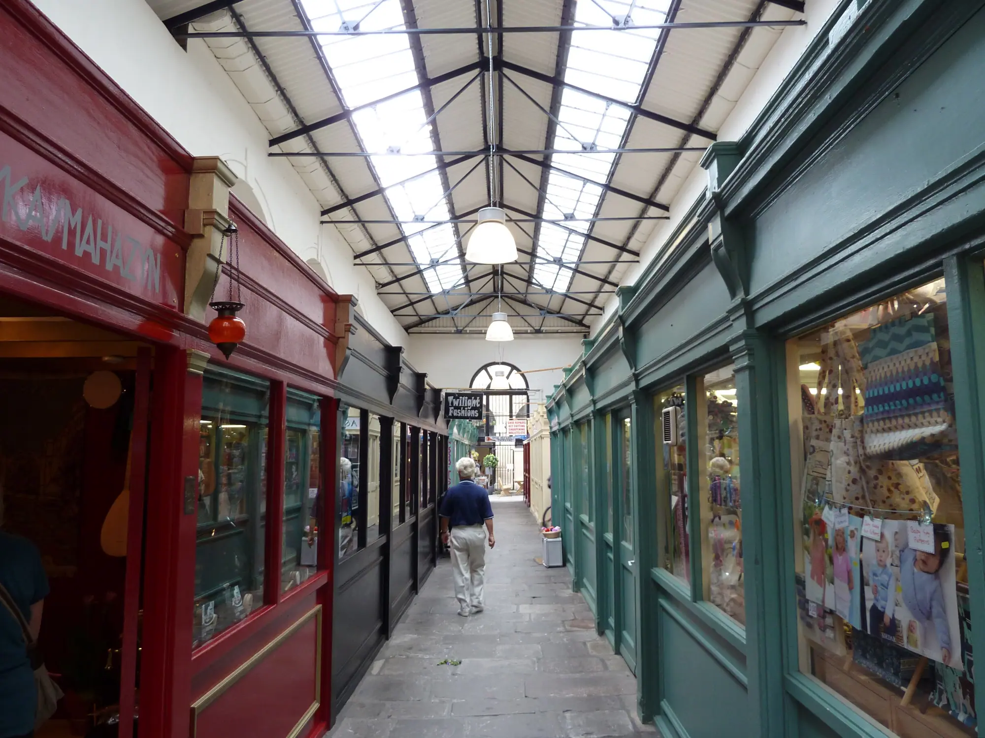 A covered passageway of stalls in St Nicholas Market, Bristol
