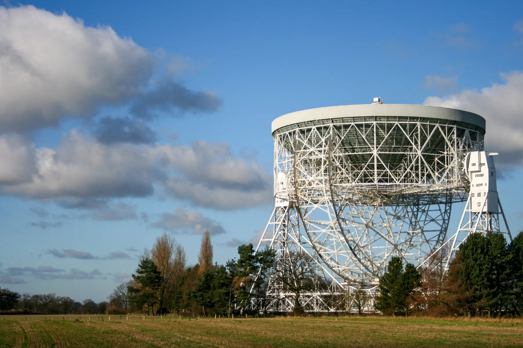 The Lovell radio telescope dish standing against a blue sky