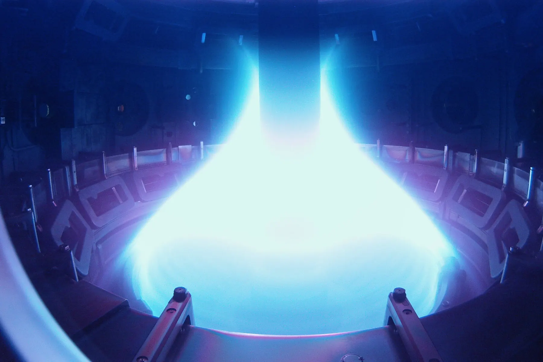 Bright blue and white fusion plasma glowing inside the vessel of the MAST tokamak