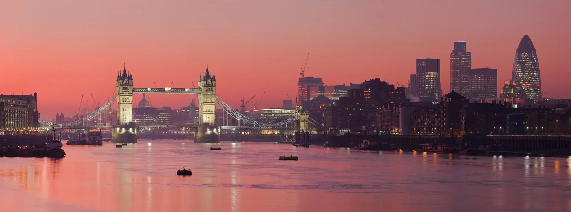 London skyline and Tower Bridge along the Thames at sunset